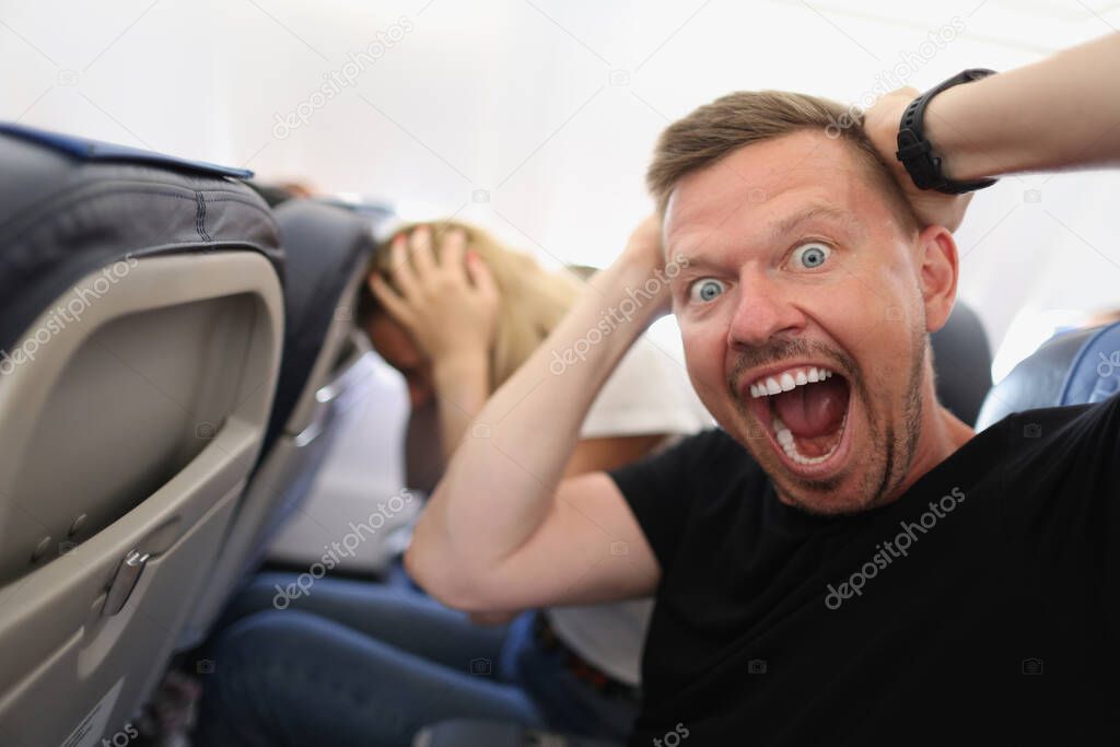 Man flying in airplane and screaming in fear