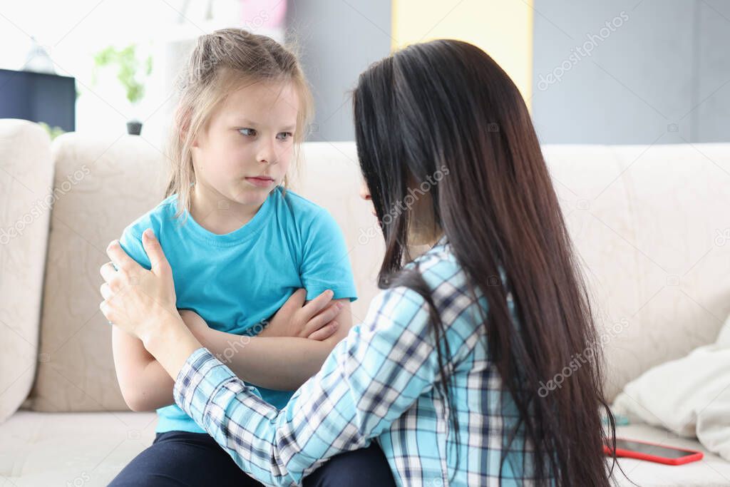 Llittle offended girl communicates with mother at home