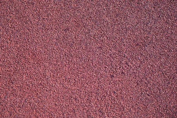 Closeup of red rubber floor covering for playground