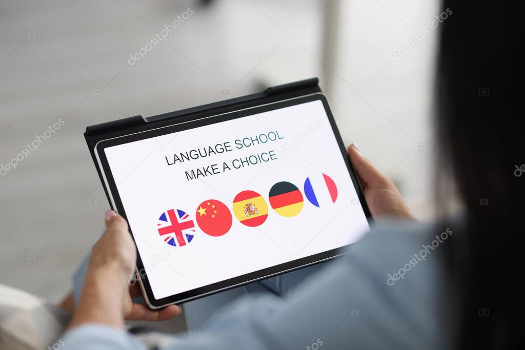 Woman holds tablet and chooses a foreign language to study