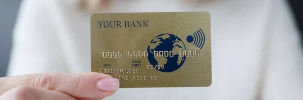 Female hand holding credit bank card closeup