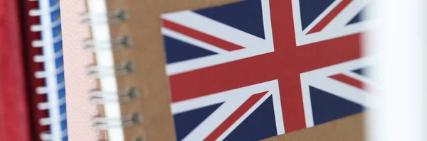 Books with English flag are on shelf closeup