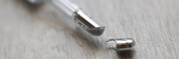 Broken mercury thermometer lies on floor closeup