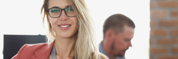 Portrait of smiling businesswoman at workplace in office