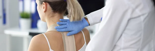 Doctor fixes posture corrector to patient closeup — Stock Photo, Image