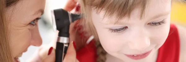 Doctor conducts medical examination of ear of little girl — Stock Photo, Image