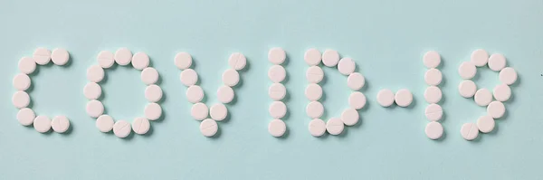 Inscrição covid 19 é feito de comprimidos brancos — Fotografia de Stock