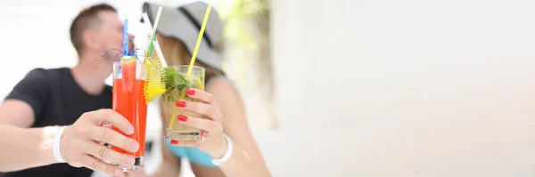 Homem e mulher segurando coquetéis alcoólicos e beijando — Fotografia de Stock