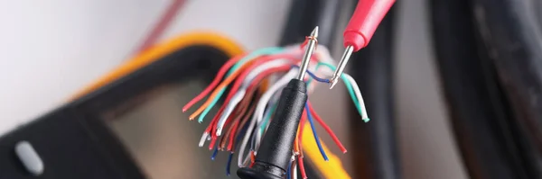 Two multimeter probes checking quality of network wiring closeup — Stock Photo, Image