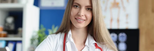 Portrait of female doctor with red stethoscope in office — стоковое фото