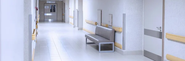Light hospital corridor with white doors closeup