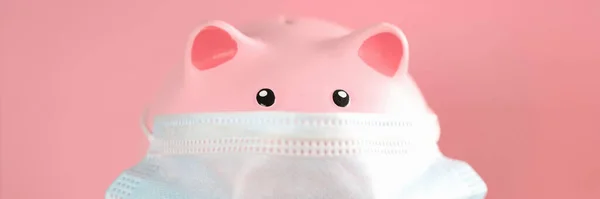 Pink pig piggy bank in protective medical mask — Stock Photo, Image