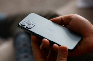 Erkek eli yeni elma iPhone 13 'ü tutuyor.