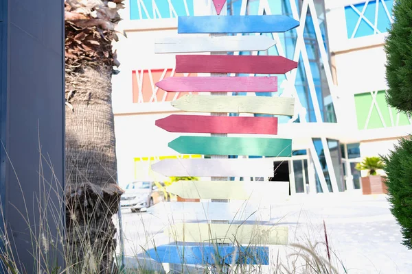 Otelin bölgesinde duran yönlü oklar şeklinde bir sürü tahta tabelalı sütun.