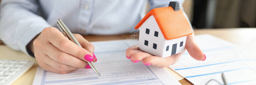 Woman concludes real estate insurance contract closeup