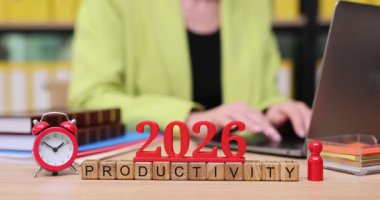 2026 için verimli bir oturuma katılan bir kişi, etkin zaman yönetimini sembolize ederek ve önümüzdeki görevlere odaklanarak renkli araçlar ve bir bilgisayar kullanır..