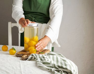 Genç bayan sarı eriklerden komposto yapıyor. Cam bir kavanozda muhafaza ediliyor. Kış için hazırlıklar, gelecekteki kullanım için