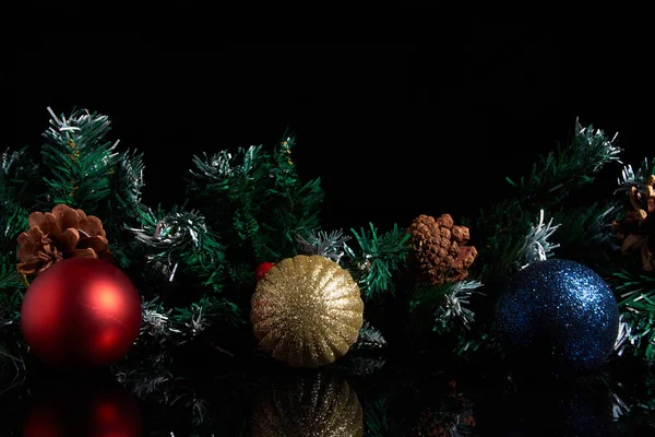 Christmas decorations and spruce branches on a black background. — Stock Photo, Image