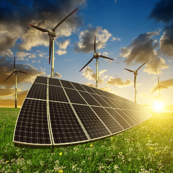 Solar panels with wind turbines in the setting sun. — Stock Photo, Image