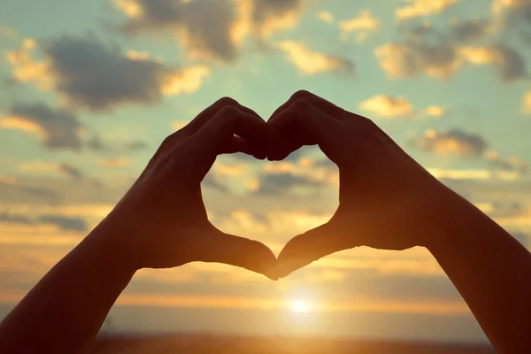 Silhouette hands forming a heart shape — Stock Photo, Image
