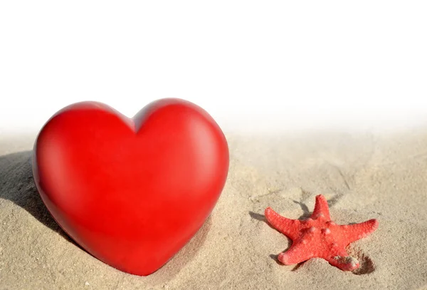 Starfish with heart in sand — Stock Photo, Image