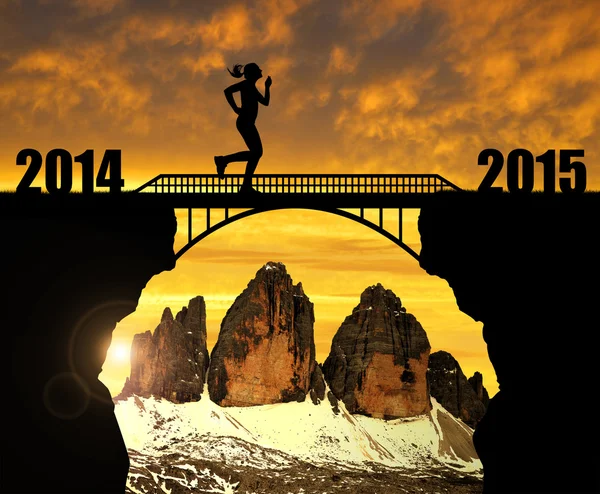 Girl running across the bridge to the New Year 2015 — Stock Photo, Image