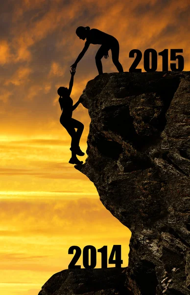 Silhouette girls climbs into the New Year 2015 — Stock Photo, Image