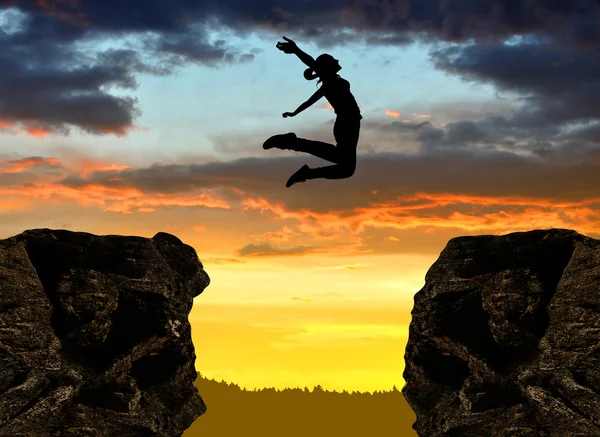 Silhouette the girl jumping over the gap — Stock Photo, Image