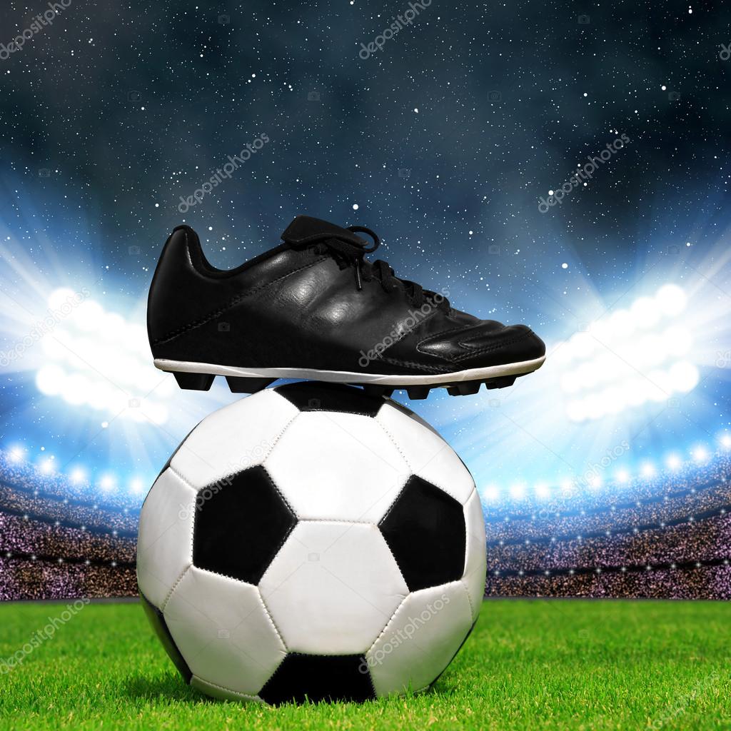 Soccer ball and shoes in grass