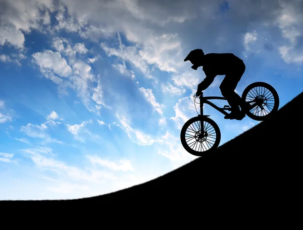 Silhouette of the cyclist on downhill bike — Stock Photo, Image