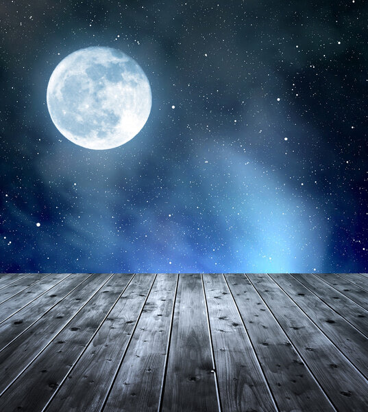 Night sky with stars and moon. In the foreground a wooden planks.