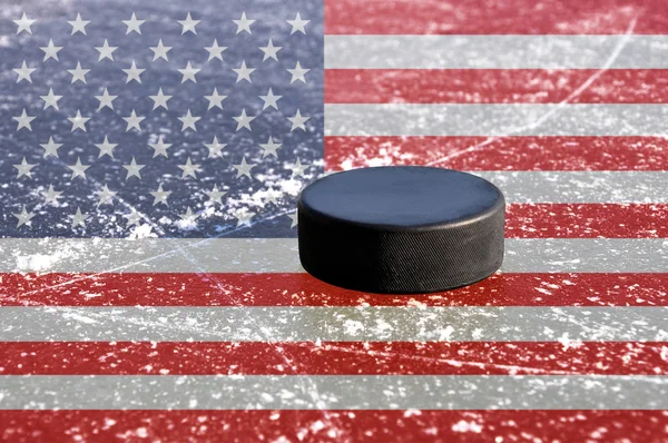 Black hockey puck on ice rink — Stock Photo, Image