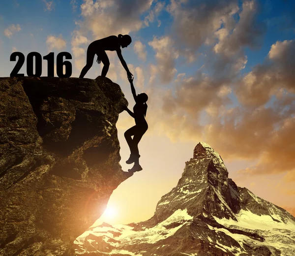 Silhouette girls climbs into the New Year 2016 — Stock Photo, Image