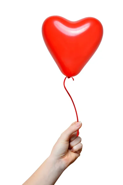 Mano sosteniendo un globo rojo del corazón — Foto de Stock