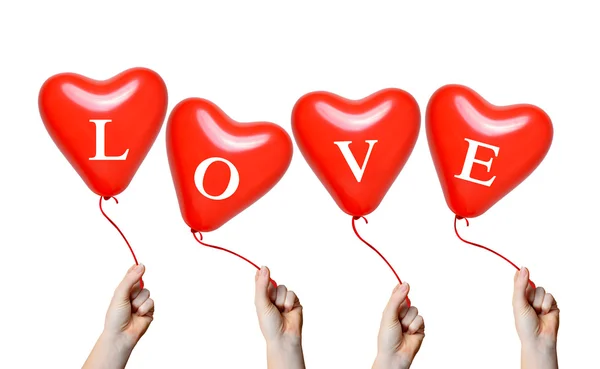 Hand holding a red heart balloons — Stock Photo, Image