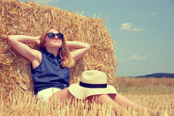 Femme reposant sur une balle de paille — Photo