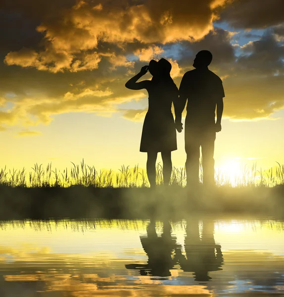 Silhouette of men and women holding hands — Stock Photo, Image