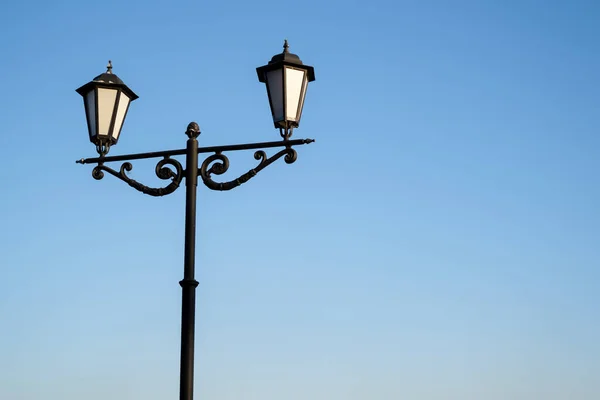 Daytime vintage street lamp post lantern lanterns in park with sky and clouds