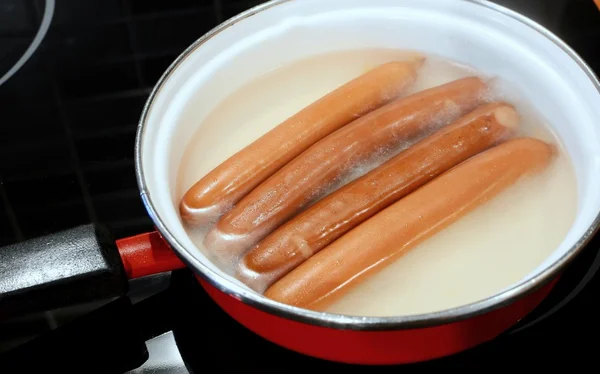 Boilling sausages in water — Stock Photo, Image