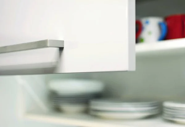 Closeup Opened Grey Kitchen Cabinet Door Metal Handle Plates Mugs — Stock Photo, Image