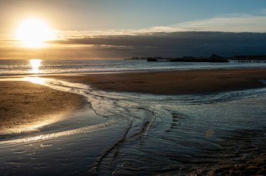 Sunset near the beach of Aptos, California, showing a ship wreck in the distance