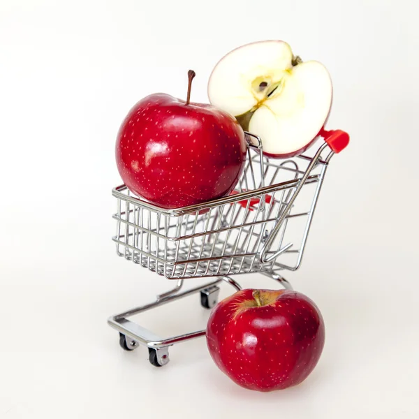 Red apples in the tiny cart for products — Stock Photo, Image