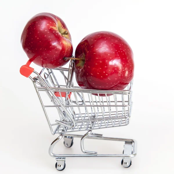 Red apples in the tiny cart for products — Stock Photo, Image