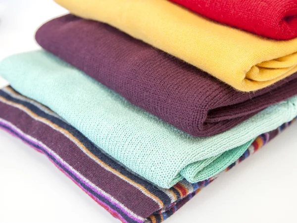 Pile of multi-colored jumpers on a show-window of shop — Stock Photo, Image