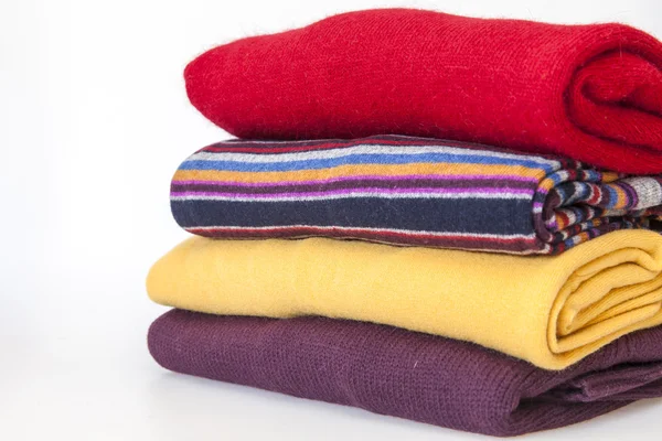 Pile of multi-colored jumpers on a show-window of shop — Stock Photo, Image