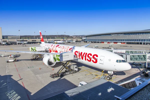 ZURICH, SWITZERLAND, on MARCH 26, 2016. New leader of SWISS Boeing 777-300ER airline. Preflight service at the airport of Zurich. View from a survey terrace of the airport.