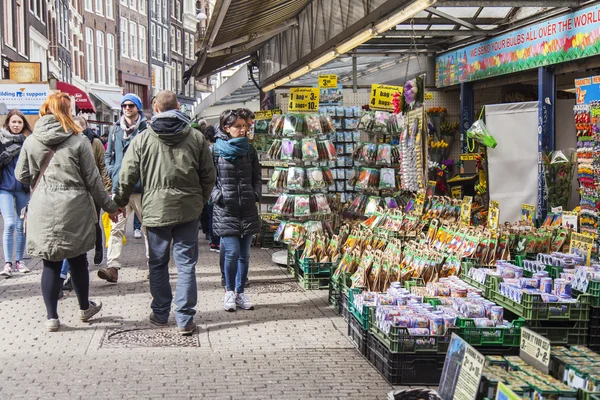 AMESTERDÃO, PAÍSES BAIXOS em 27 de março de 2016. Os turistas caminham no mercado de flores. O mercado de flores é um dos pontos turísticos da cidade — Fotografia de Stock