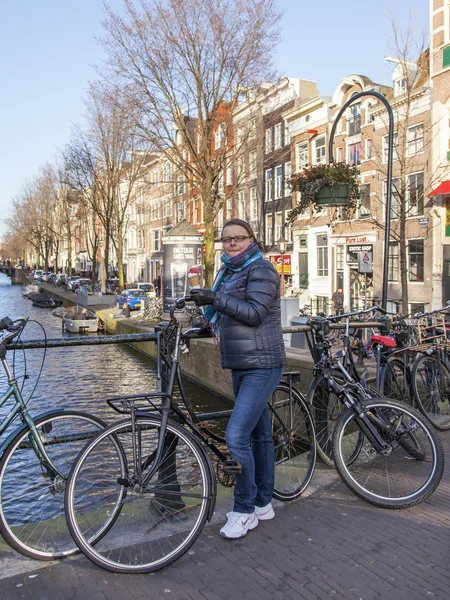 AMSTERDAM, PAESI BASSI il 27 marzo 2016. Paesaggio urbano. La donna con il gelato sul ponte contro la città — Foto Stock