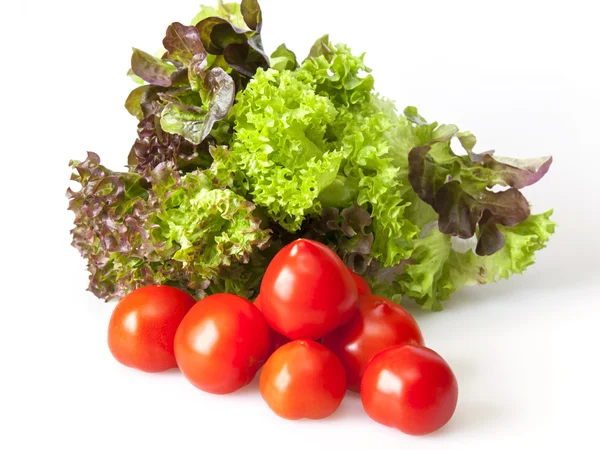 Ripe red tomatoes and lettuce leaves — Stock Photo, Image