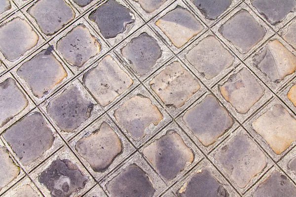 A calçada velha pavimentada por uma telha de pedra, textura — Fotografia de Stock